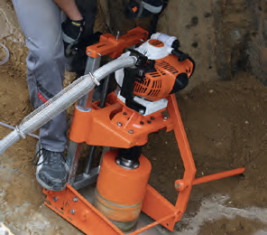 90&deg; drill in sewage pipe. Pipe base clamped between concrete pipe and trench and secured by ground spikes.